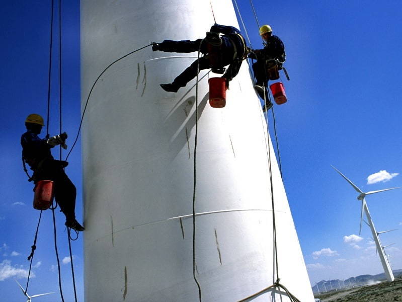 man climbing wind turbine