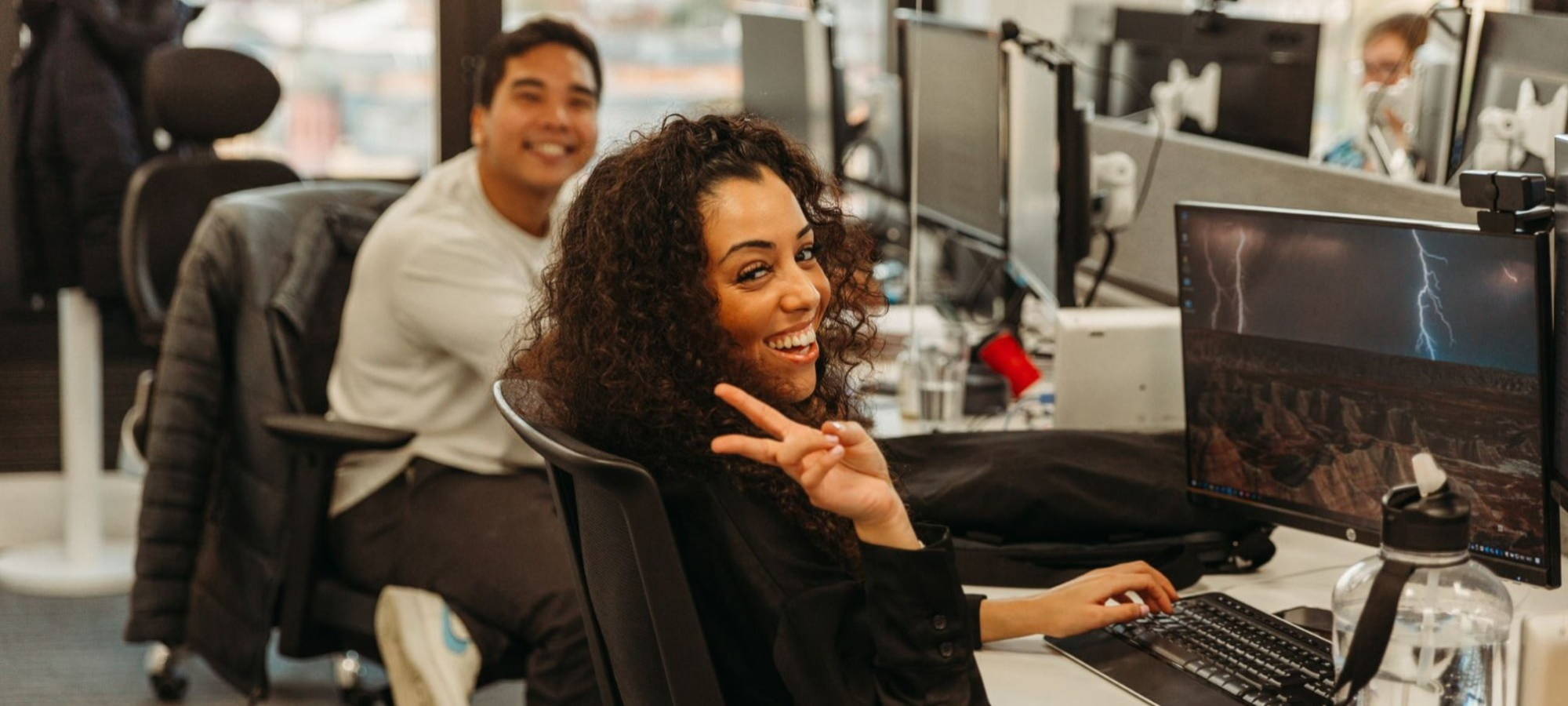 male and female employees in the ersg office smiling 